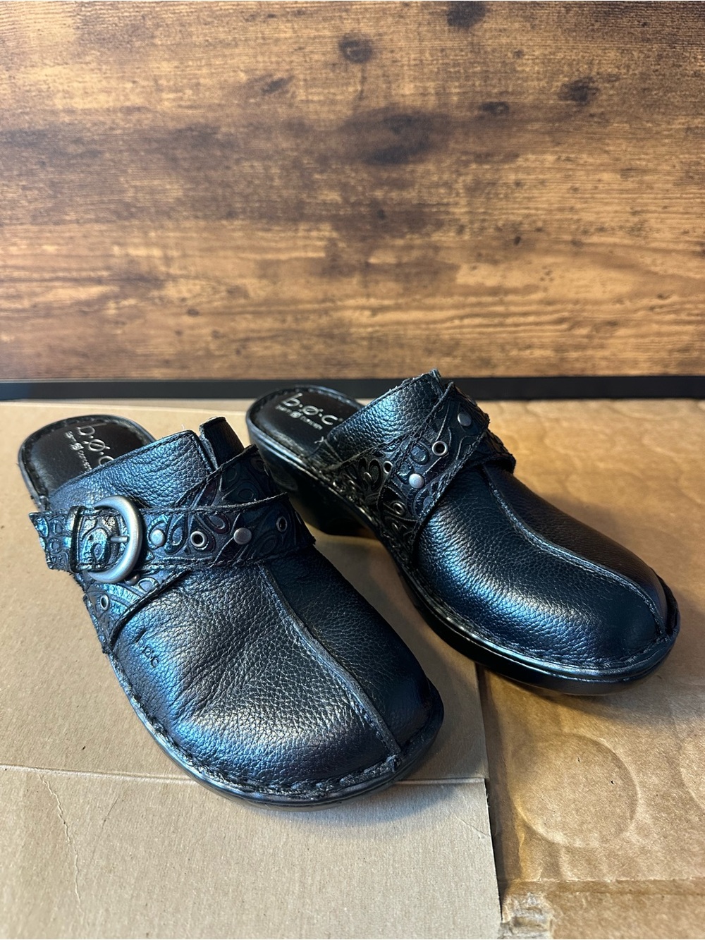 B.O.C. by Born Women 8/39 Black Leather Slip-On Clogs
Stamp Strap Accents
